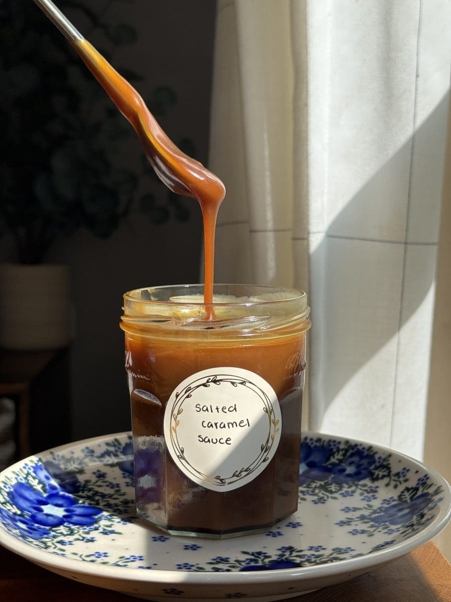 Drizzling the homemade salted caramel sauce.