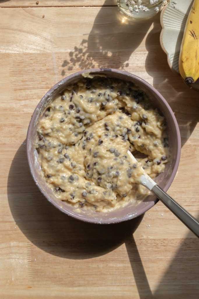 The finished banana muffin batter in a  mixing bowl.