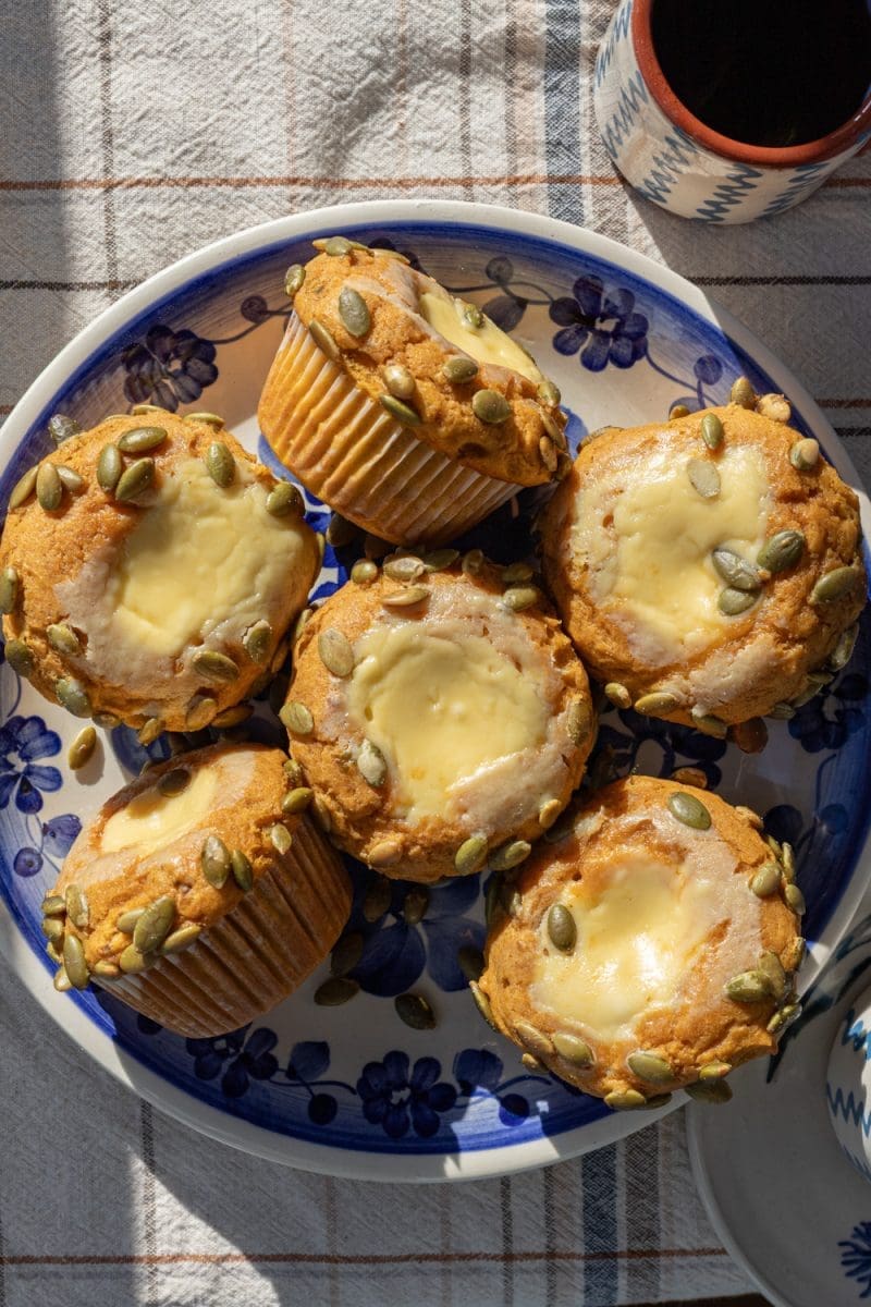 The pumpkin cheesecake muffins on a plate.