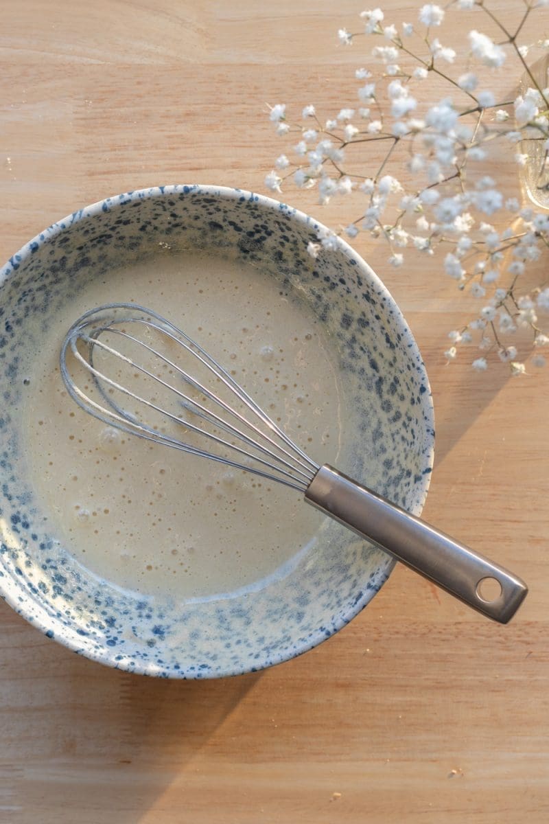 The eggs and sugar whisked together in a small mixing bowl.