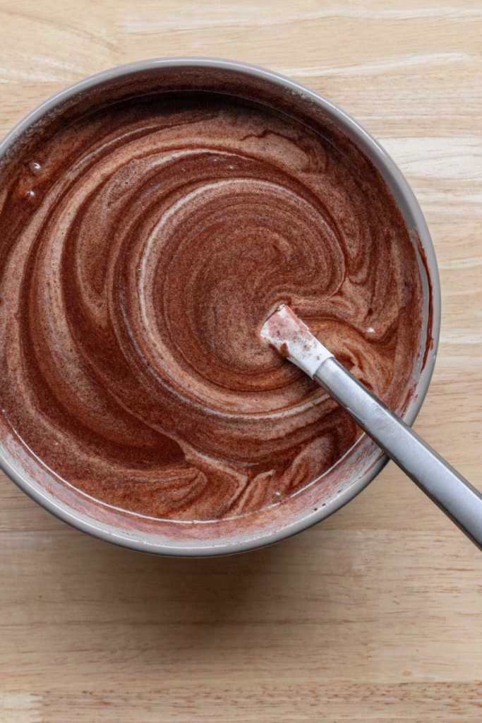 Folding the chocolate into the egg mixture.