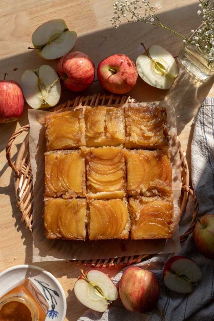 Flat lay of the sliced caramel apple upside down cake on a serving tray.