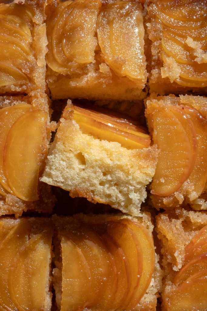Close up cross-section of a slice of caramel apple upside down cake.