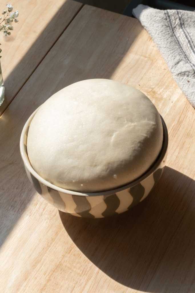 The cinnamon roll dough in a mixing bowl.
