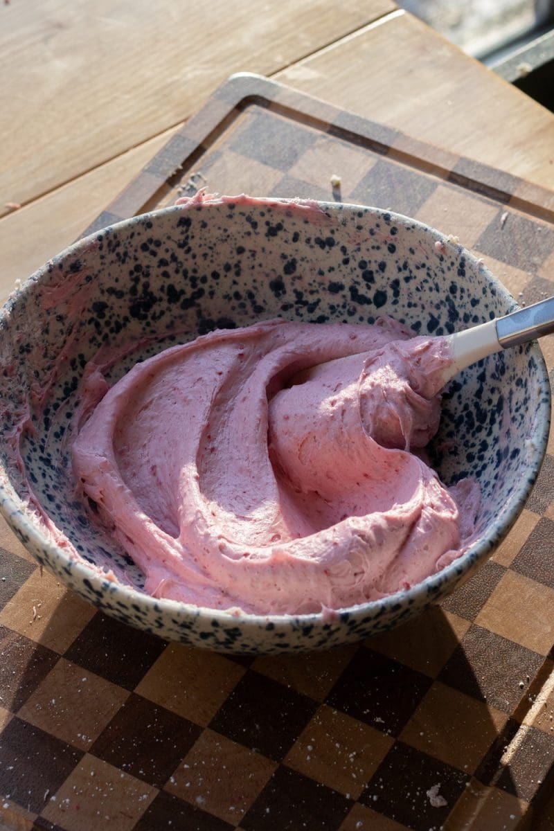 The raspberry cream cheese frosting in a mixing bowl.