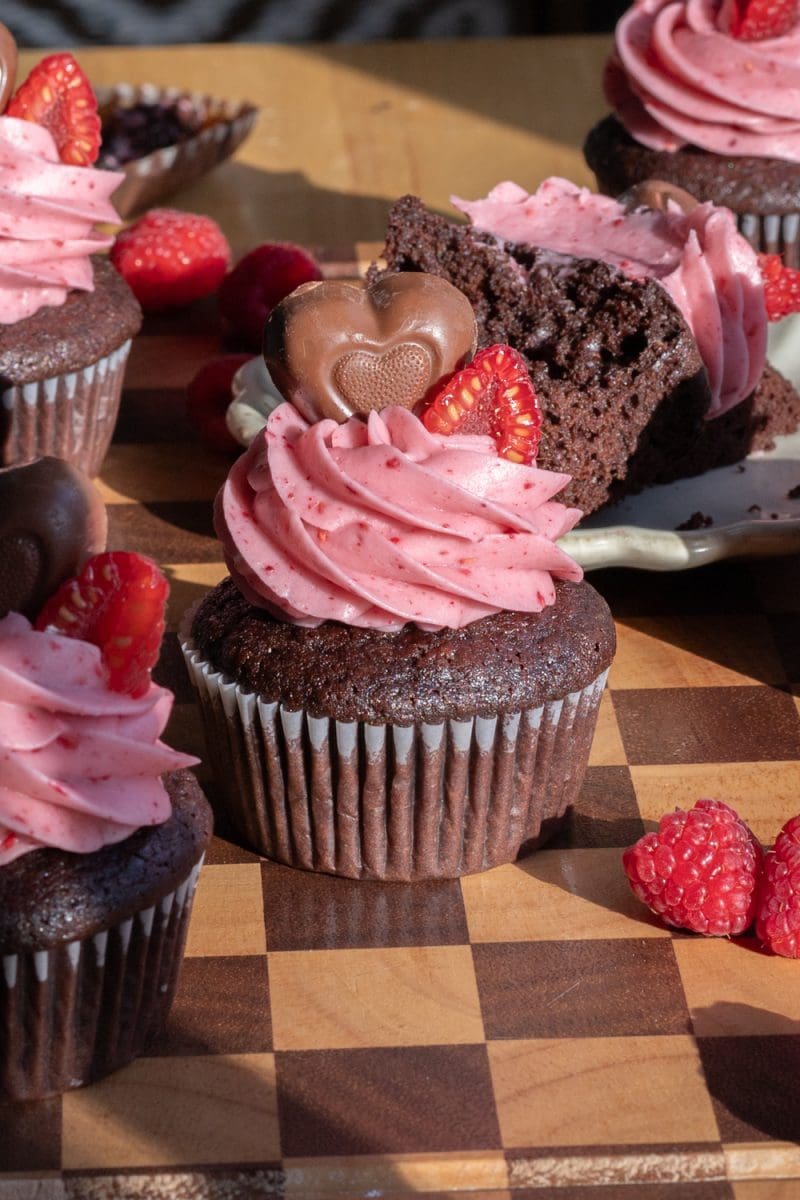 Frosted chocolate raspberry cupcakes on a tray.