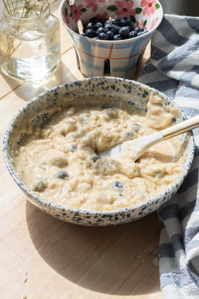 The finished blueberry muffin batter in a mixing bowl.
