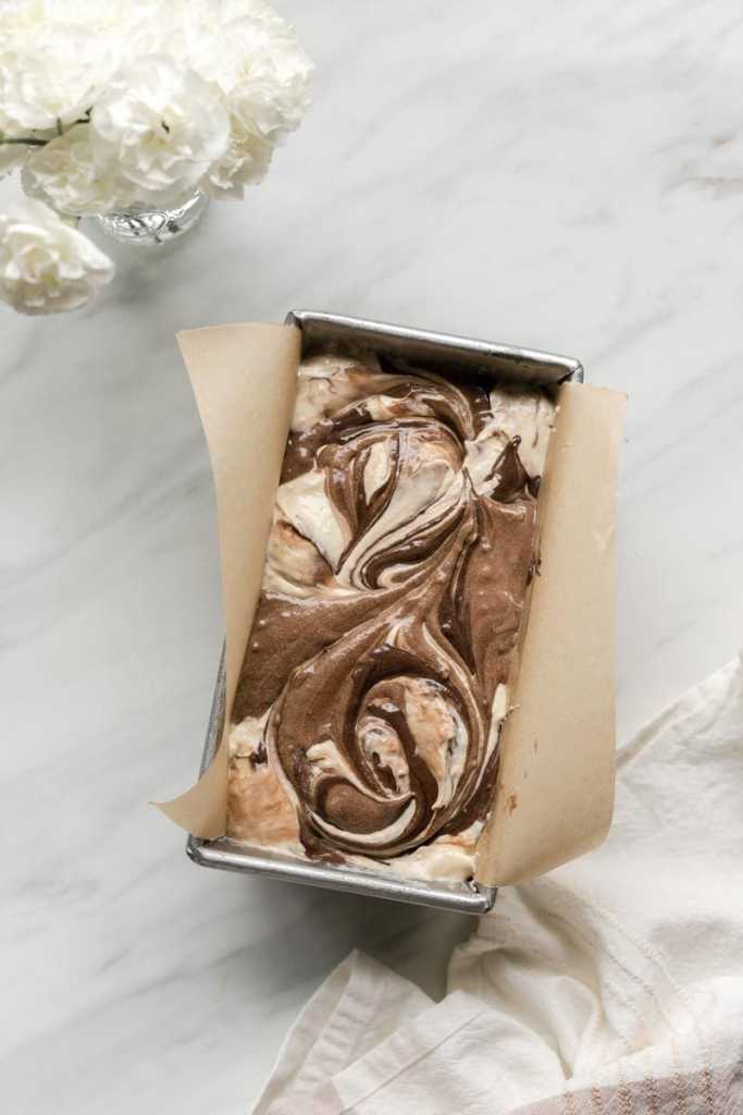 all three cake batters swirled together in the loaf pan