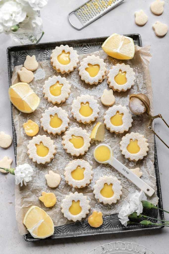 Stylized flat lay of the lemon curd linzer cookies on a tray