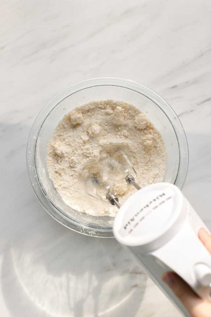 beating the butter into the dry ingredients