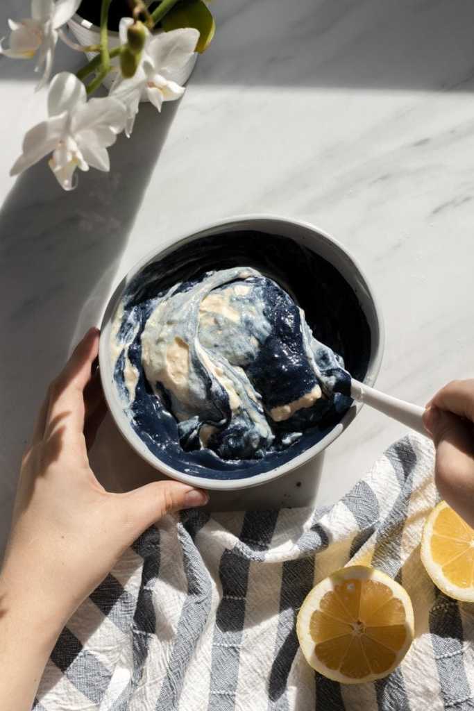 Folding the butterfly pea powder into a portion of the cake batter