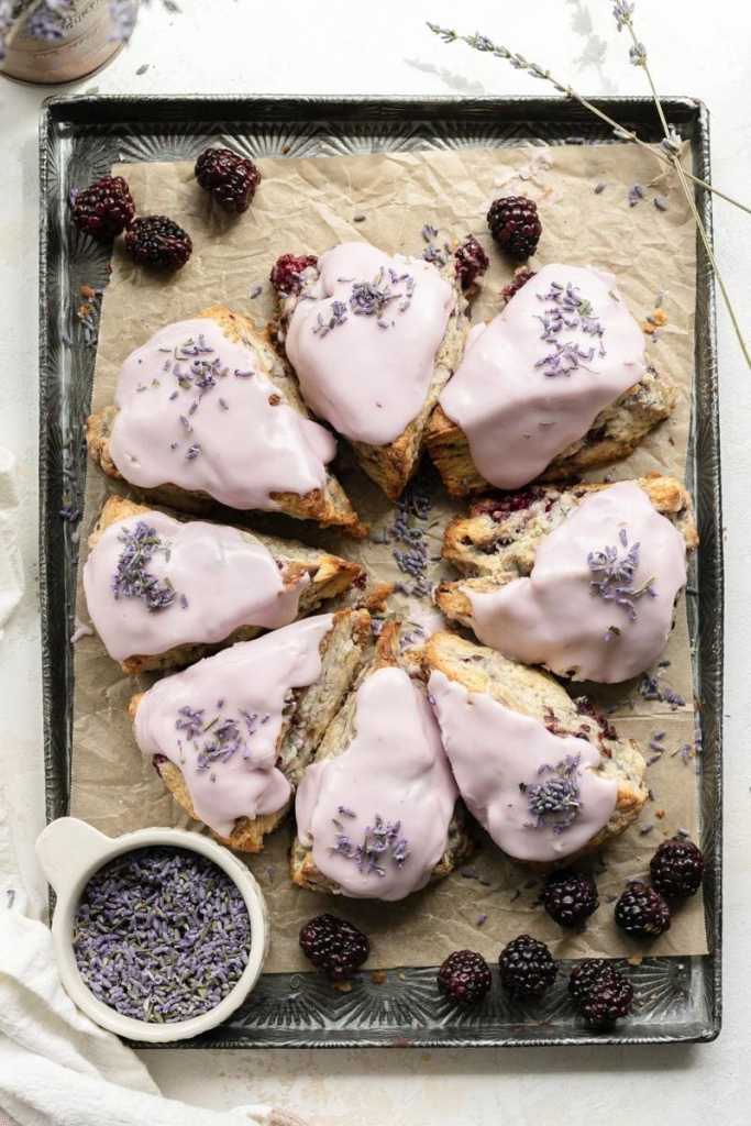 a flat lay of the blackberry lavender scones on a baking tray, all in a circle
