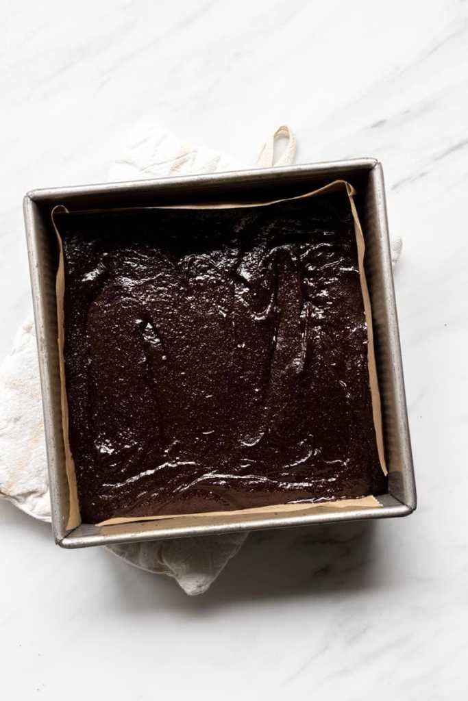 the brownie batter on top of the baked shortbread layer