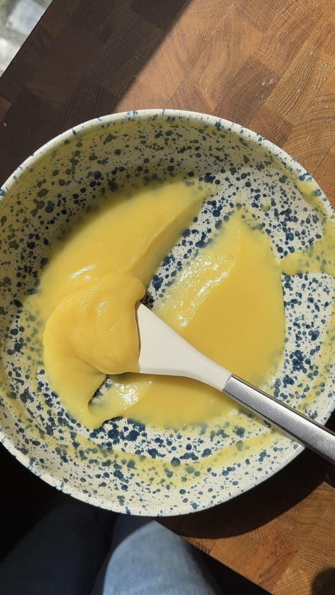 Lemon curd in a mixing bowl.