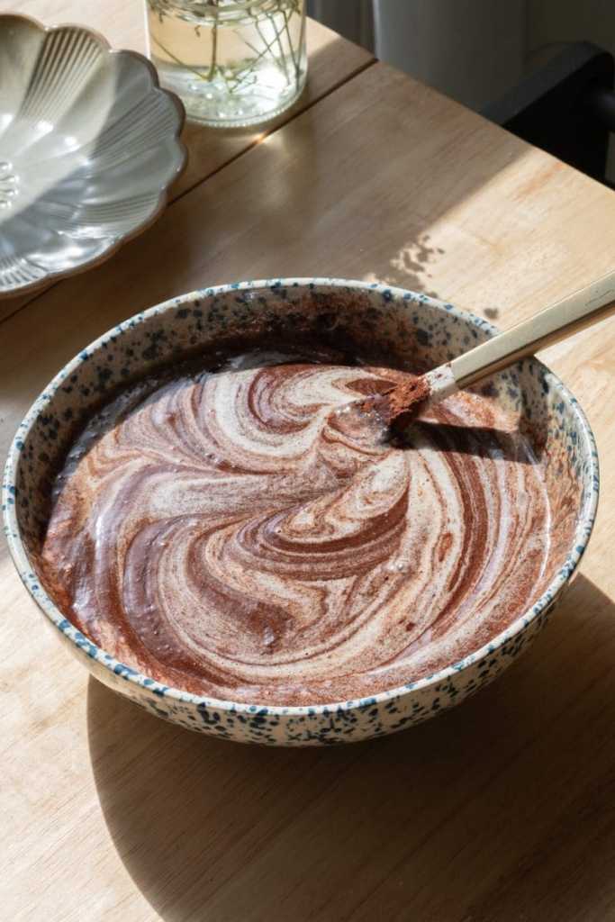 Folding melted chocolate into the eggs.