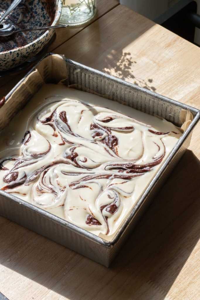 The cheesecake brownies in the pan before being baked.