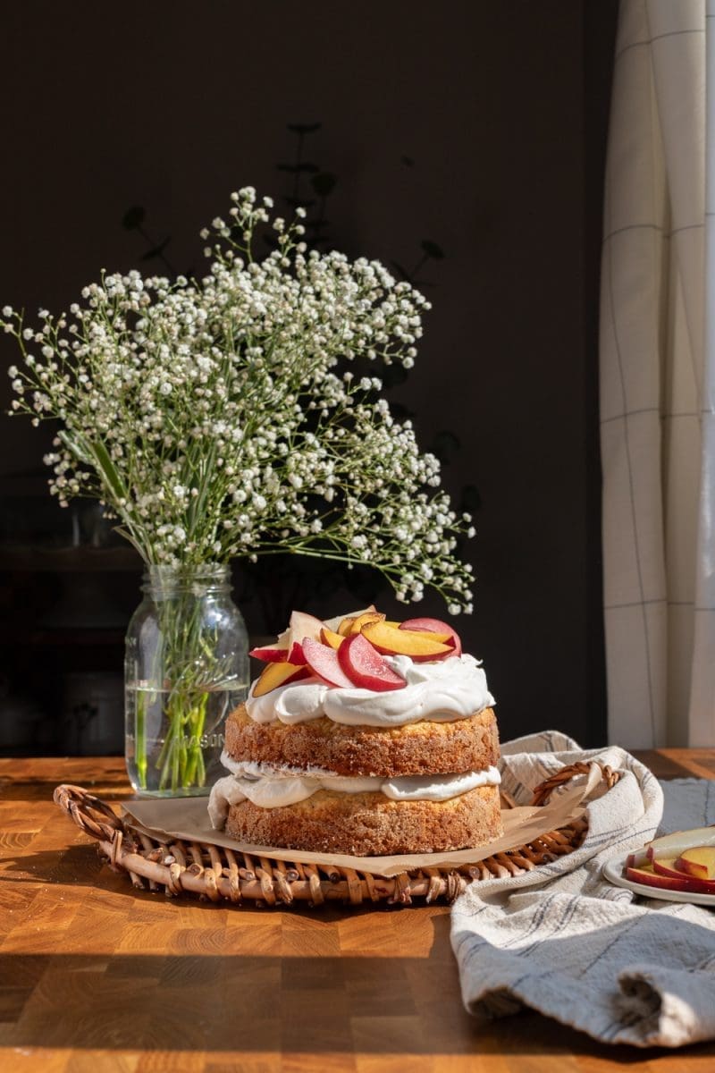 The assembled peach shortcake cake on a tray.