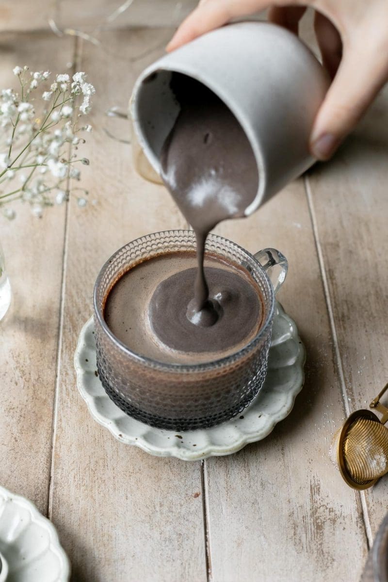 Pouring the dark chocolate cold foam over the dark chocolate mocha.