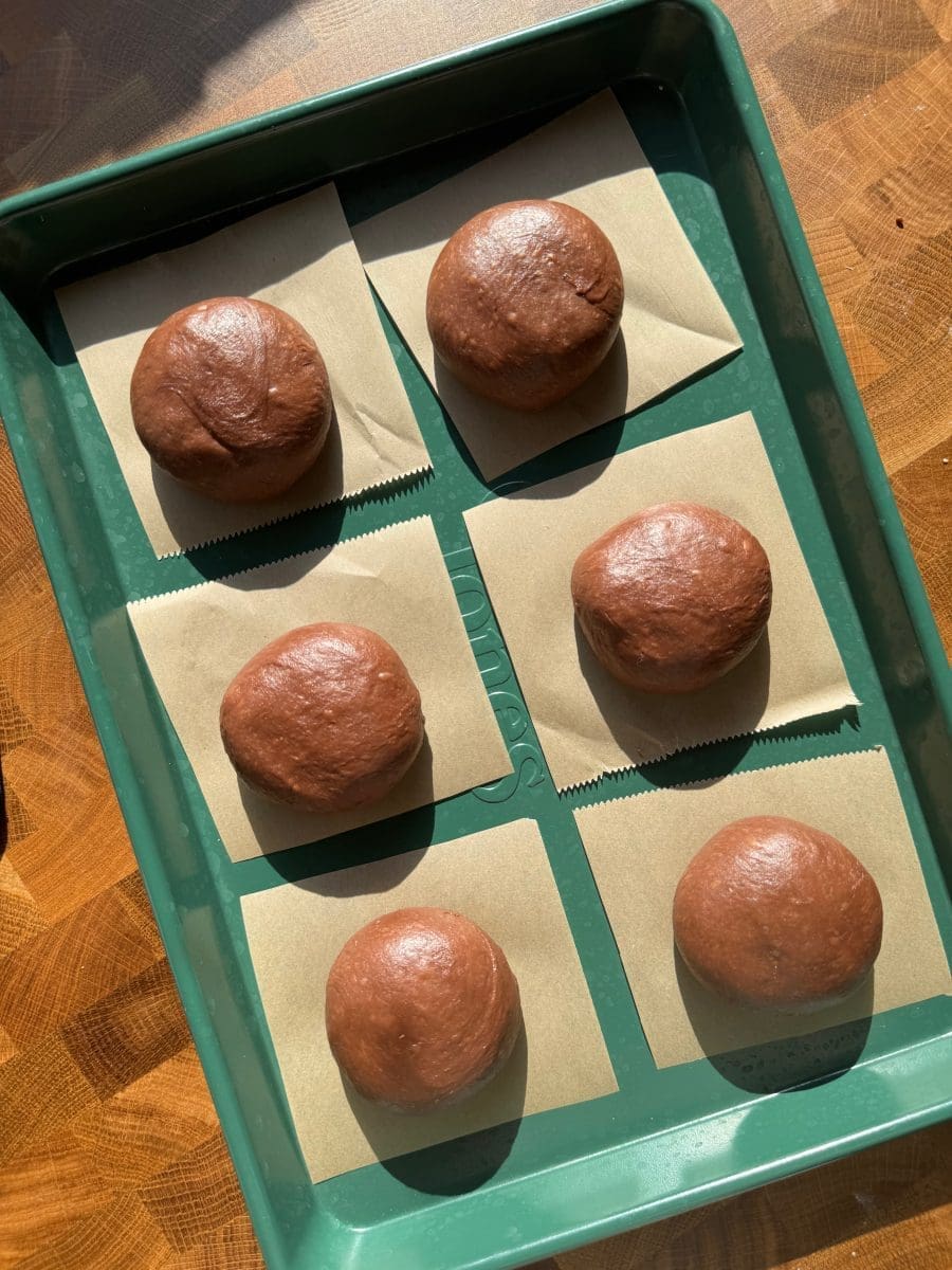 The donuts rolled up and on little parchment squares.