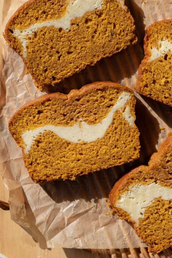 Close up of a slice of cream cheese swirl pumpkin bread
