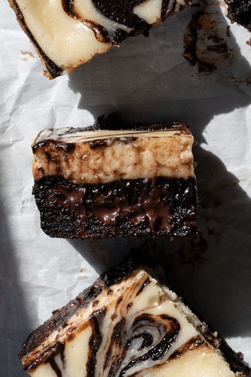 Close up cross-section of one of the dark chocolate cheesecake brownies.
