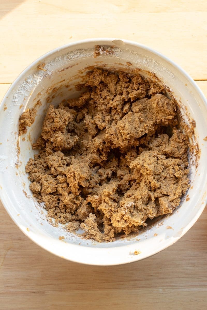 The finished gingerbread cookie dough in a mixing bowl.
