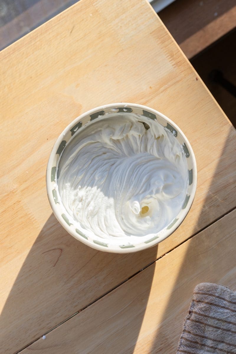 Whipped cream in a small mixing bowl.