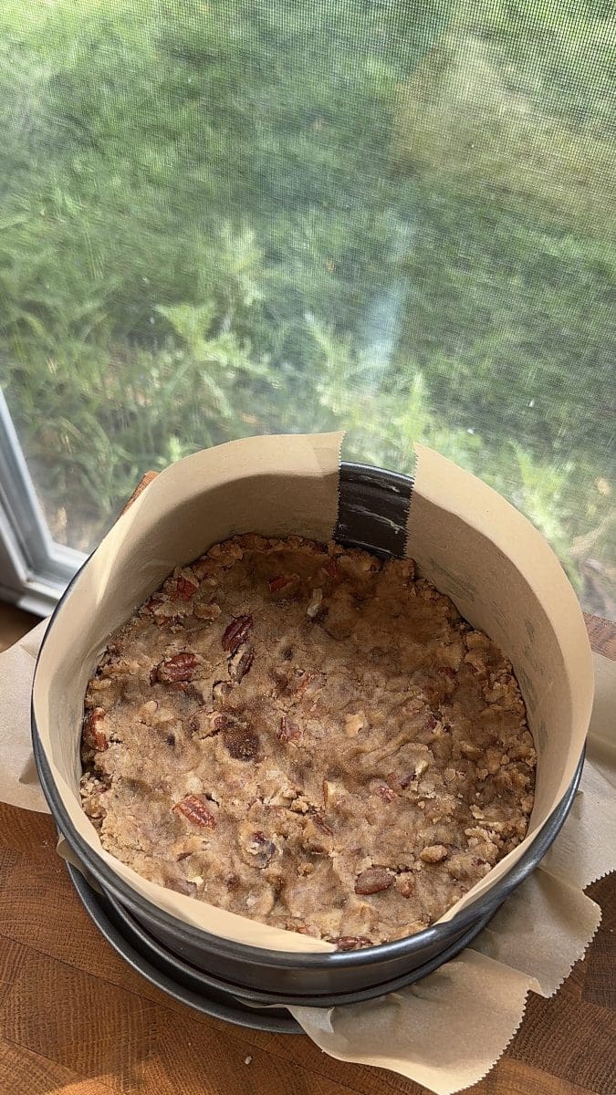 The pecan crust pressed into a springform pan.