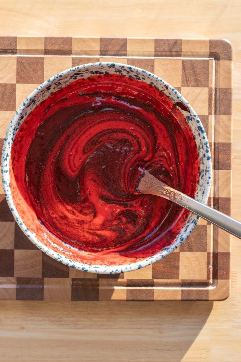 Swirling red food dye into the egg mixture.