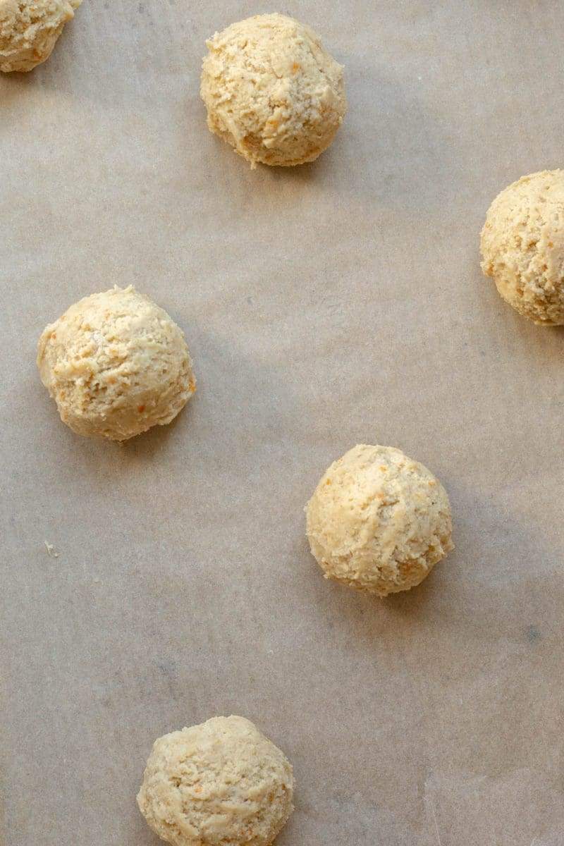 Close up of the sugar cookies before baking, on a cookie sheet.