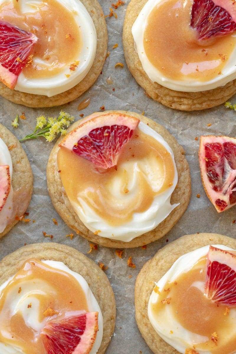 Flat lay of the blood orange cookies on a sheet of parchment, all next to each other.