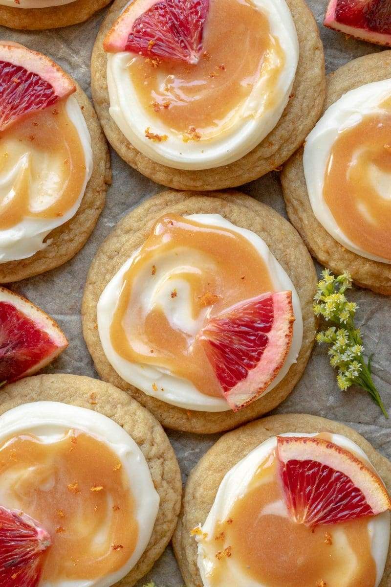 Flat lay of the blood orange cookies on a sheet of parchment, all next to each other.