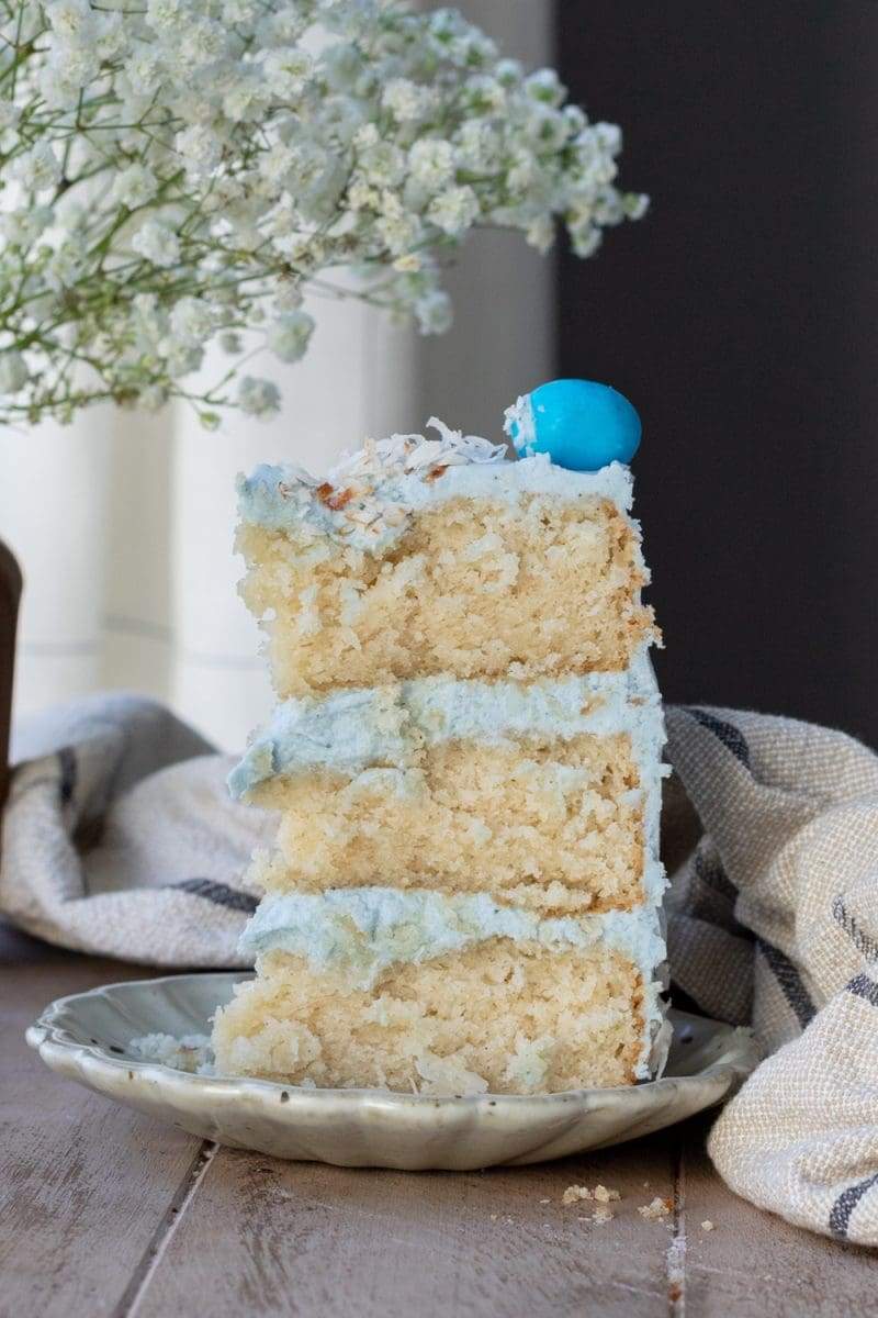 a view of one slice of the mini robin's egg cake standing up on a plate