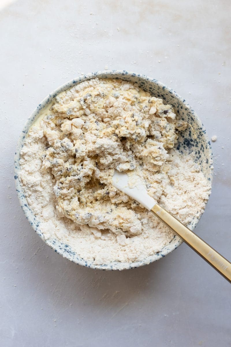 Mixing the wet ingredients into the dry ingredients.