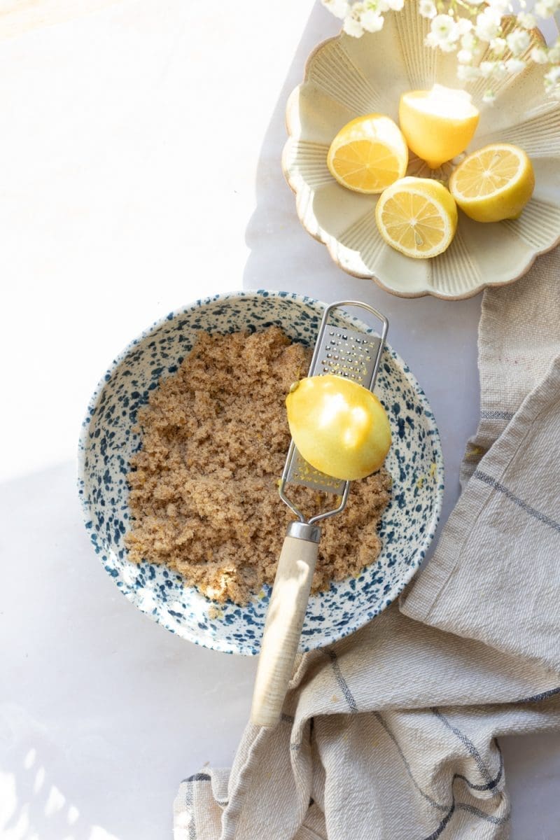 Zesting the lemon into the brown sugar.