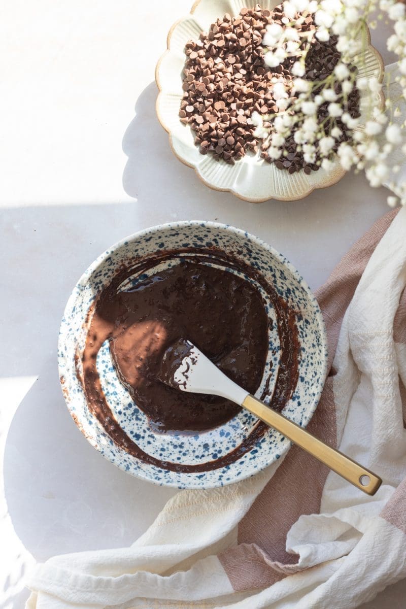 Mixing the cocoa powder and hot milk together.