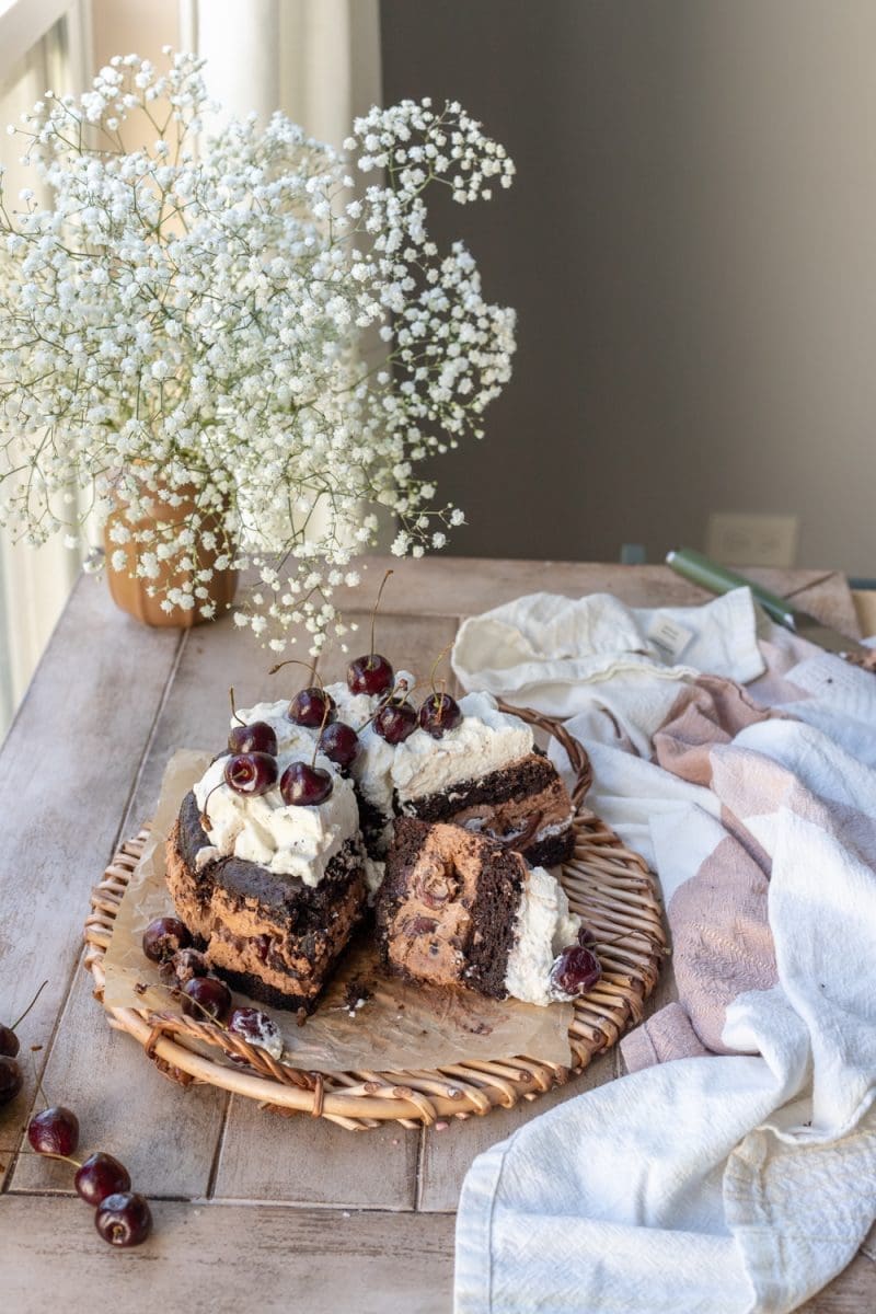 The chocolate cherry cake on a tray, sliced up.