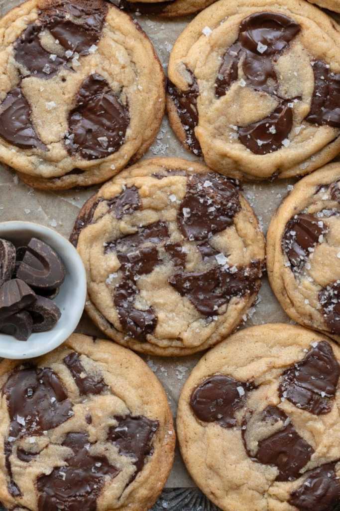 Close up of the small batch chocolate chip cookies on a tray with parchment paper.