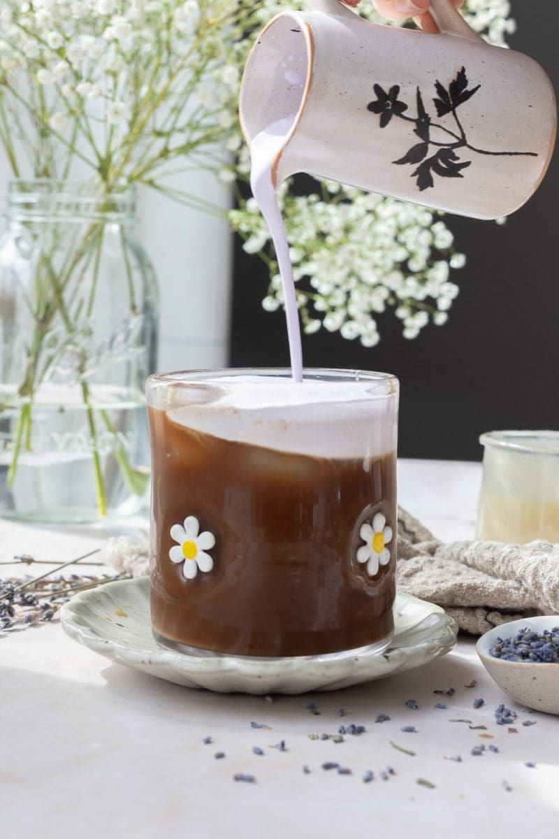 Pouring the lavender cold foam into the cup.