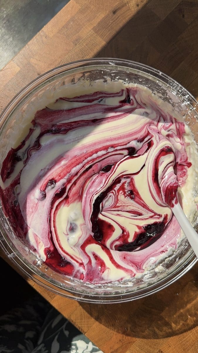 Swirling the blueberry jam into the cheesecake batter.