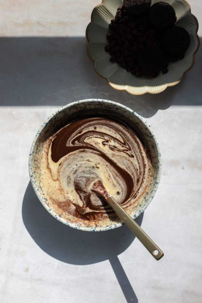 Swirling the melted chocolate mixture into the egg mixture.