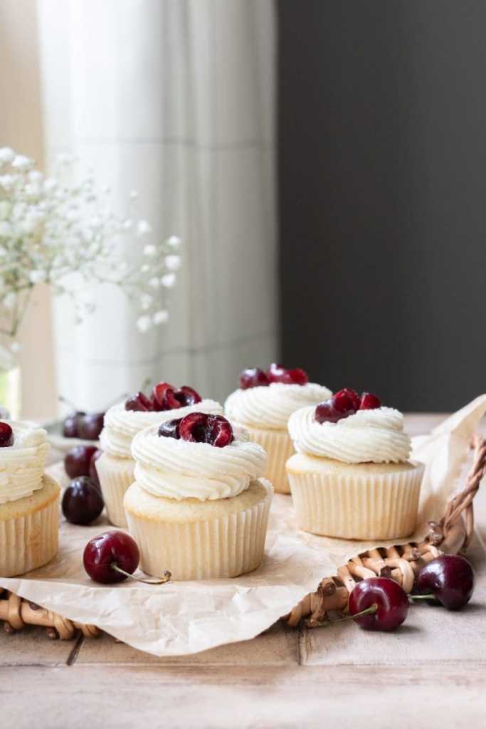 The white chocolate cherry cupcakes spaced out on a tray.
