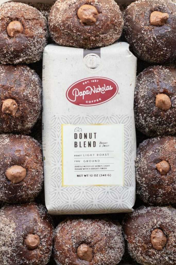 Chocolate coffee donuts surrounding a bag of coffee