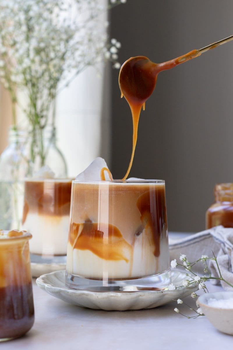 Drizzling salted caramel sauce over the macchiato.