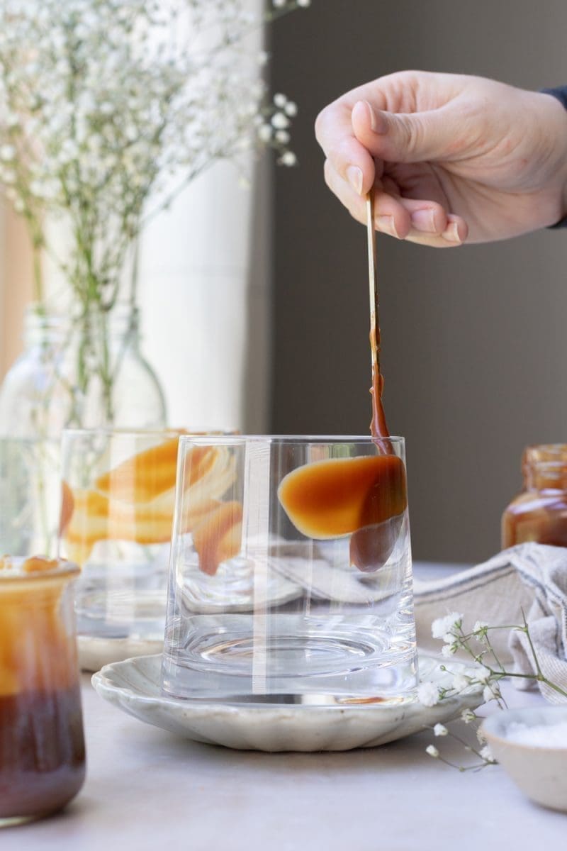 Spreading caramel on the inside of the cup.
