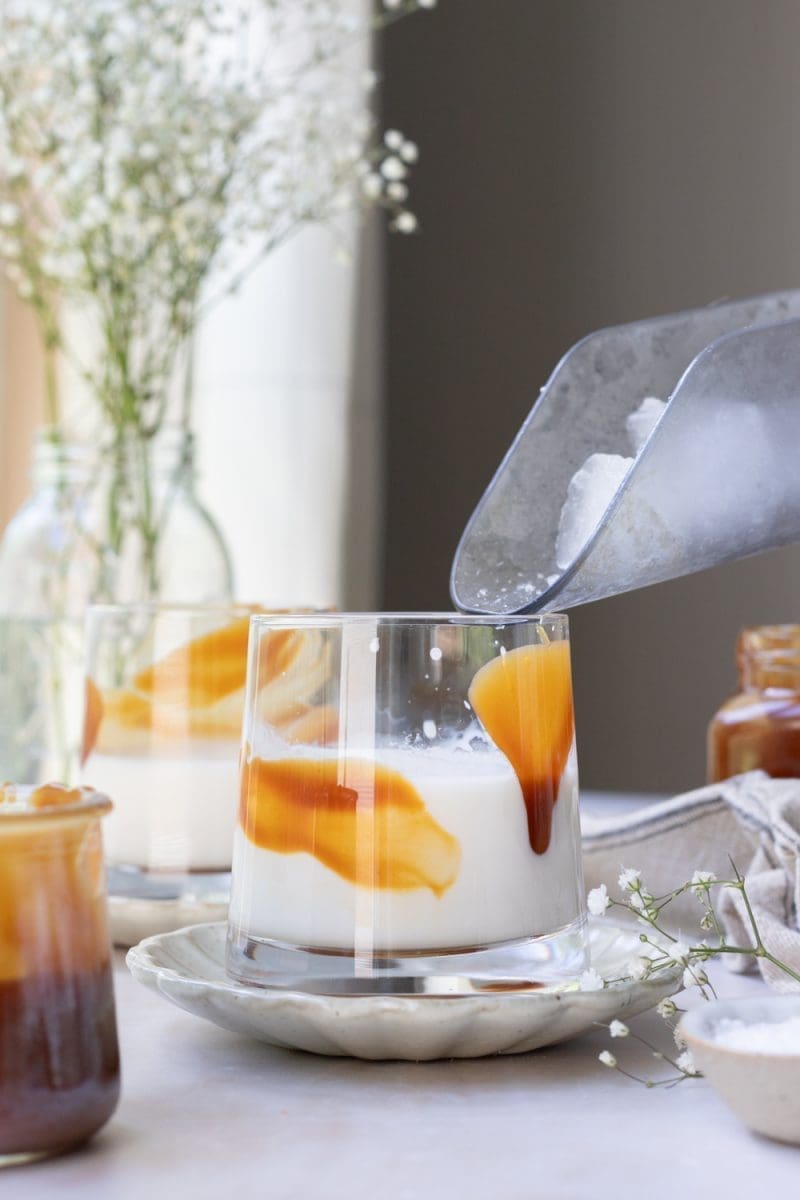 Adding ice into the cup.