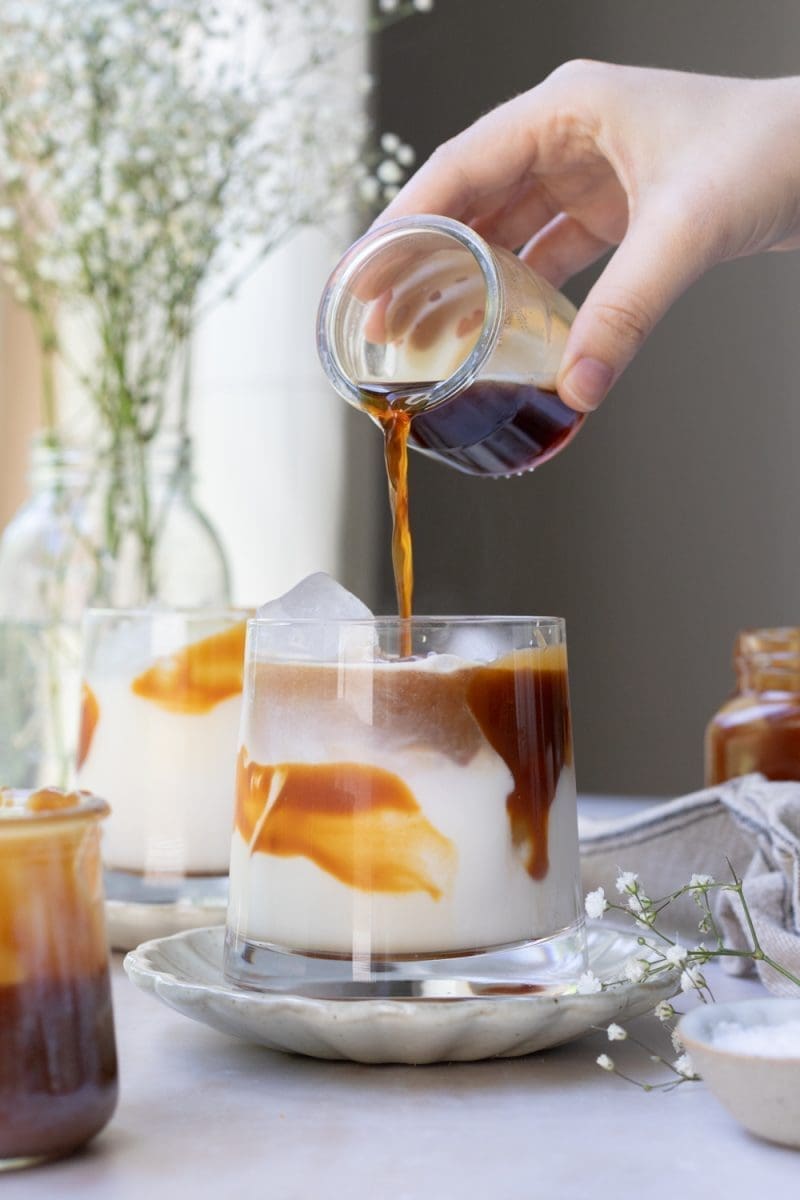 Pouring the espresso over the milk.