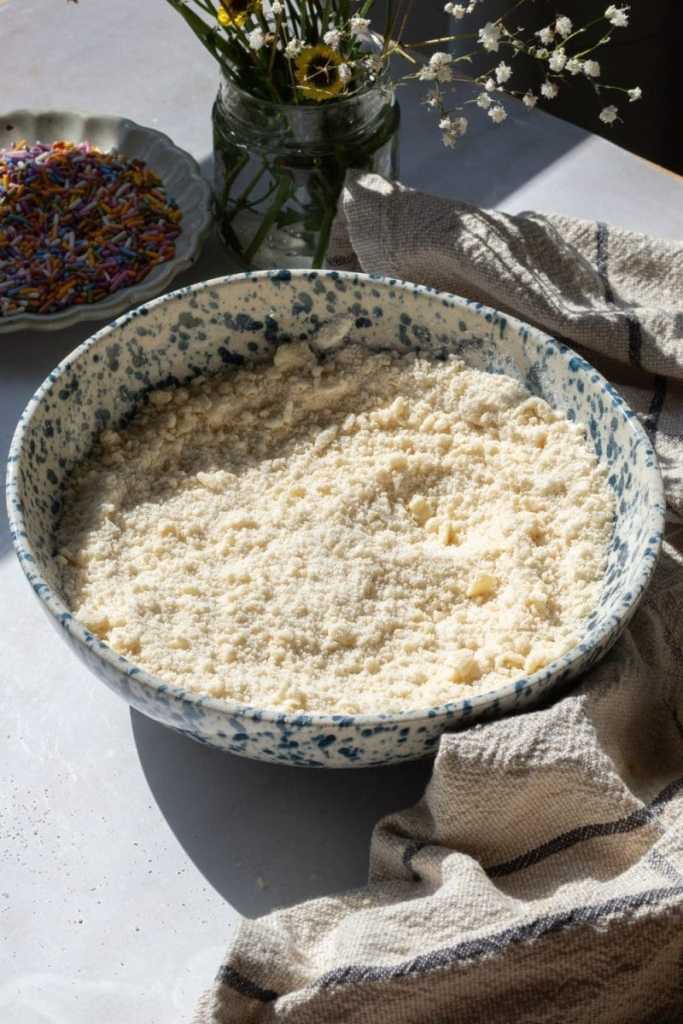 The dry ingredients and butter beaten together in a mixing bowl.