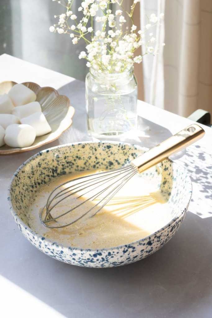 The eggs and sugar whisked together in a mixing bowl.