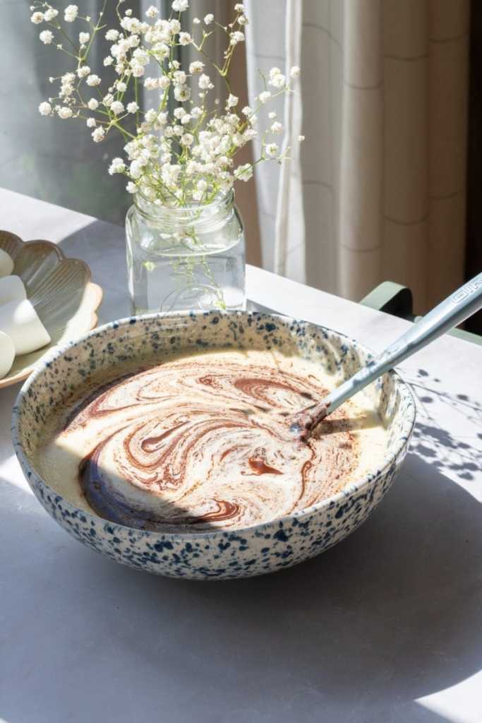 Swirling the melted chocolate mixture into the eggs.